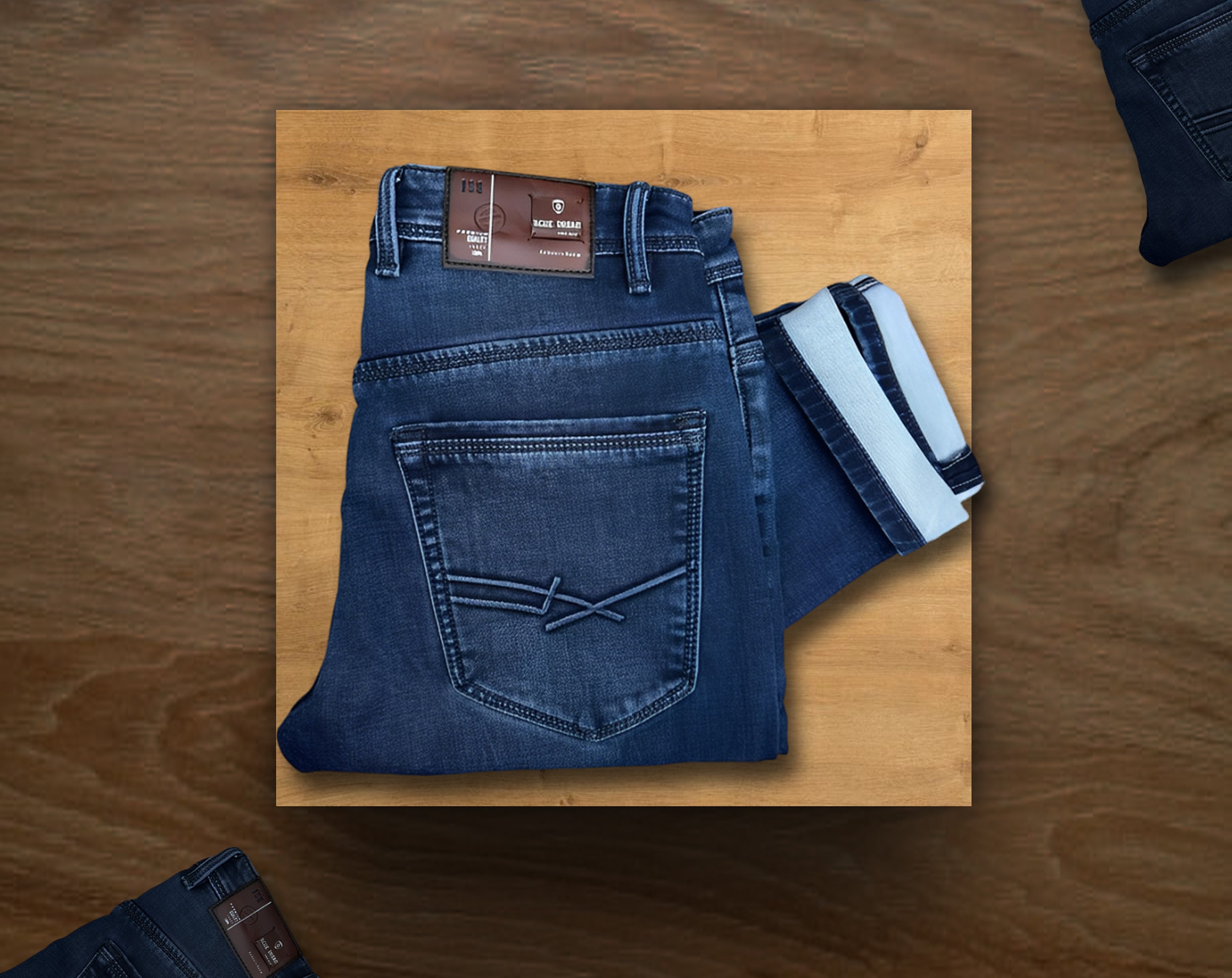Folded blue jeans with a brand label on a wooden surface